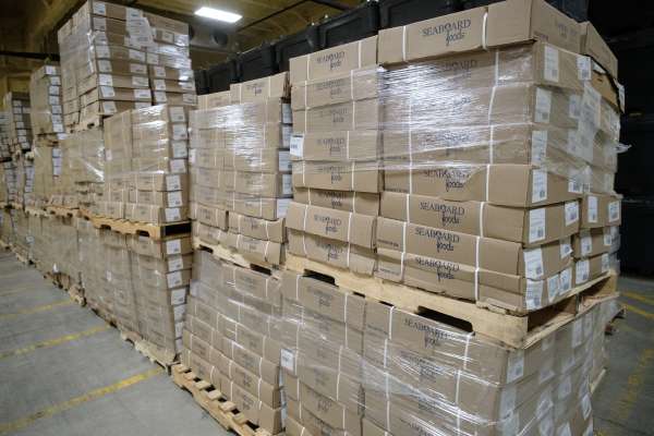 Photo of Stacks of product in a warehouse.